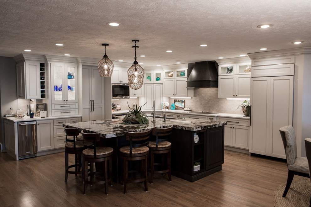Inspiration for a mid-sized transitional eat-in kitchen remodel with shaker cabinets, white cabinets, quartz countertops, stainless steel appliances and an island