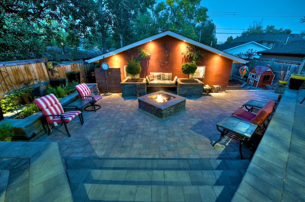 Design ideas for a small traditional backyard patio in Calgary with a fire feature, concrete pavers and no cover.