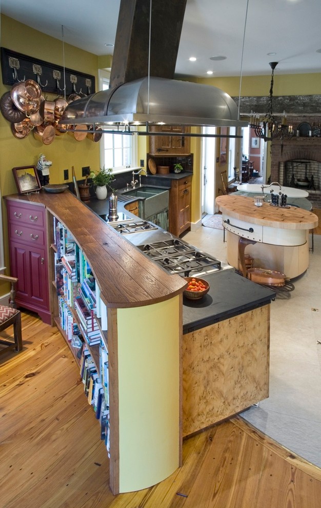 Example of a mid-sized transitional galley kitchen pantry design in DC Metro with flat-panel cabinets and an island