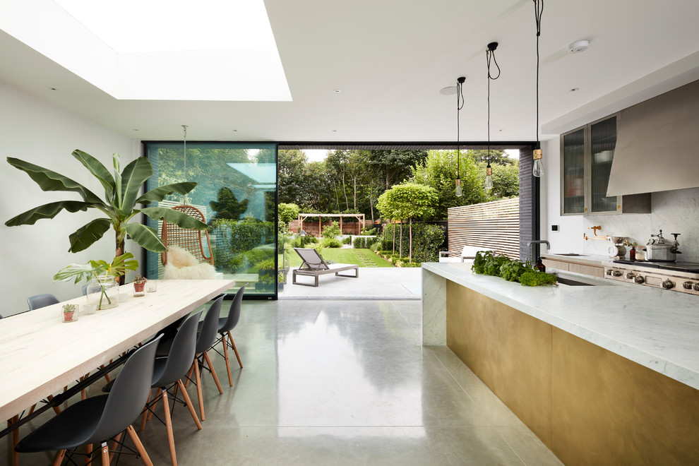 Inspiration for a contemporary open plan kitchen in London with marble benchtops and with island.