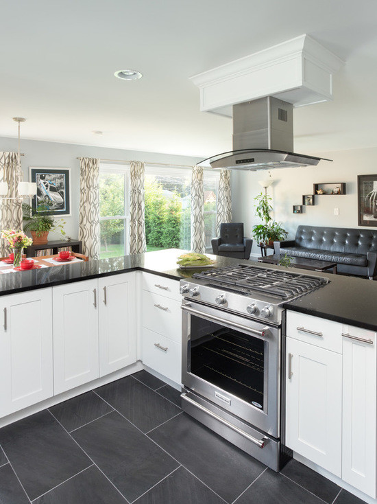 Open concept kitchen - large transitional l-shaped medium tone wood floor open concept kitchen idea in Chicago with an undermount sink, shaker cabinets, white cabinets, granite countertops, multicolored backsplash, ceramic backsplash, stainless steel appliances and no island