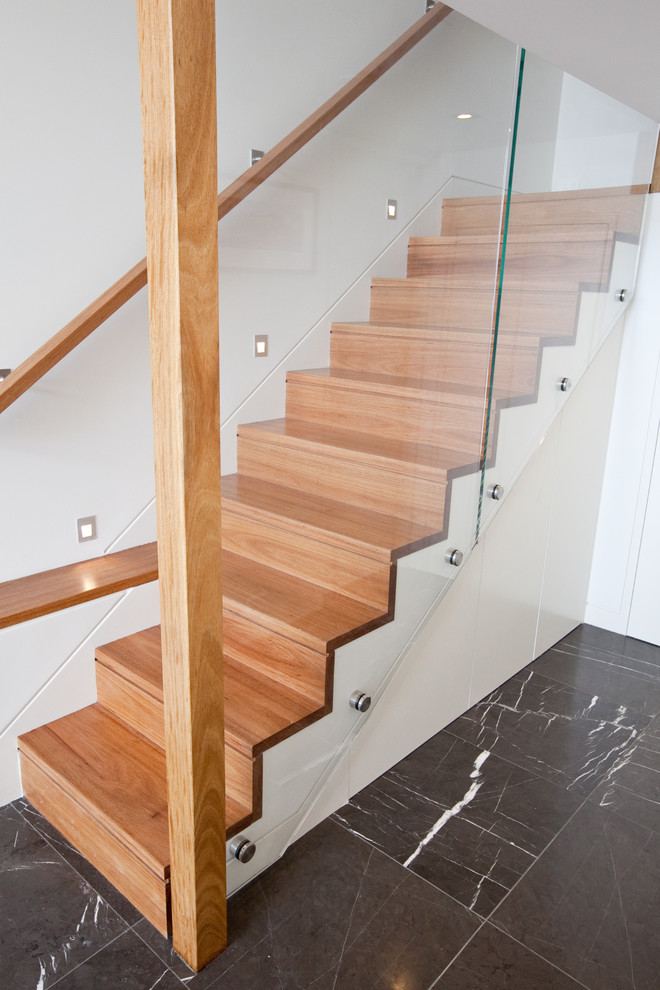 This is an example of a mid-sized contemporary wood straight staircase in Sydney with wood risers.