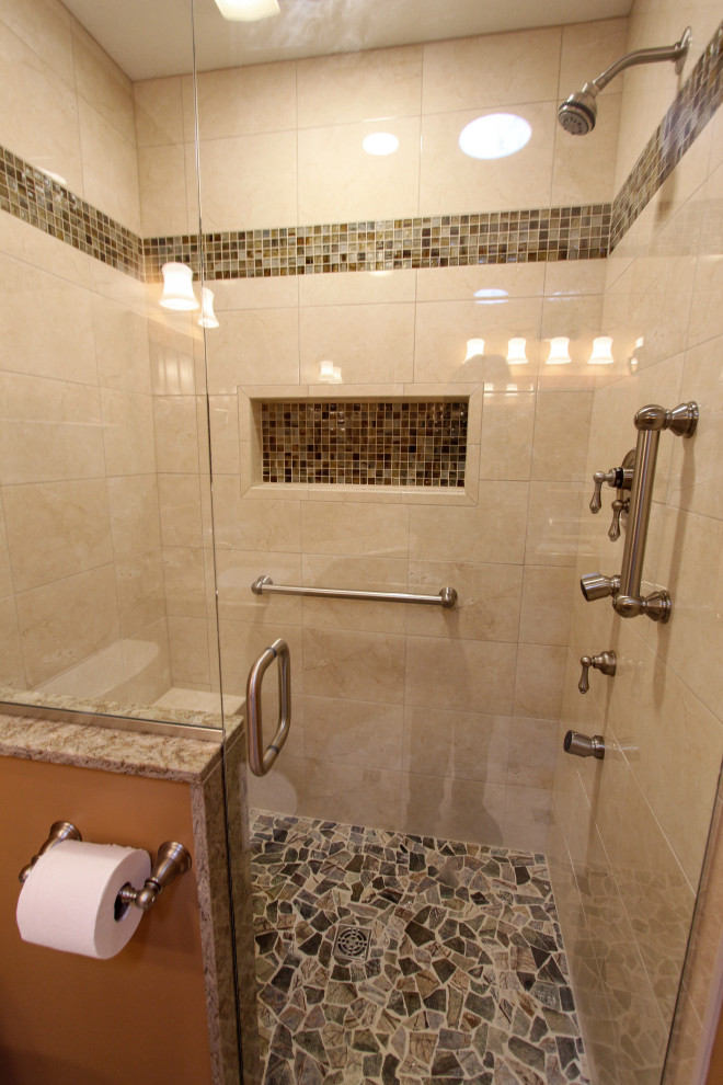 Mid-sized traditional master bathroom in Cleveland with raised-panel cabinets, medium wood cabinets, an alcove shower, a two-piece toilet, beige tile, ceramic tile, orange walls, porcelain floors, an undermount sink, engineered quartz benchtops, beige floor, a hinged shower door and beige benchtops.