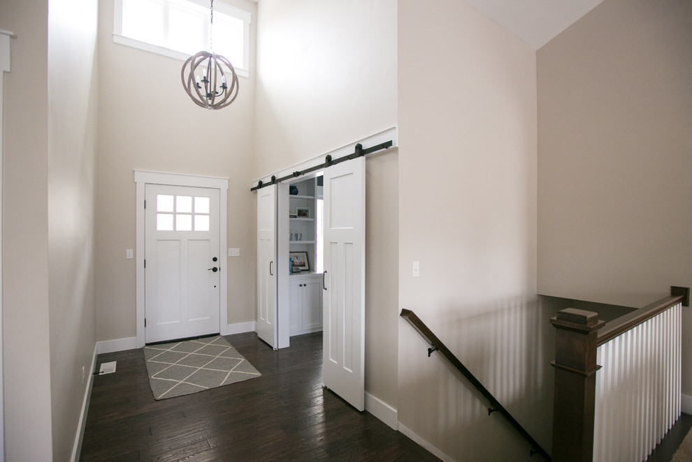 This is an example of an arts and crafts foyer in Other with grey walls, dark hardwood floors, a single front door and a white front door.