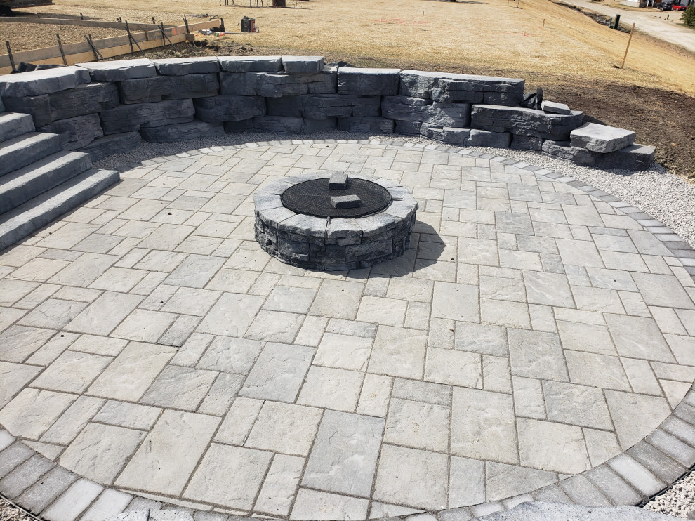 Inspiration for a large rustic full sun backyard concrete paver retaining wall landscape in Edmonton for summer.