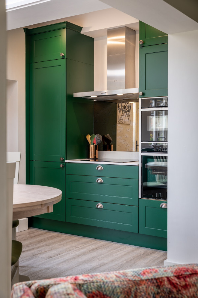 Inspiration for a small traditional l-shaped eat-in kitchen in Sussex with shaker cabinets, green cabinets, quartzite benchtops, black appliances and white benchtop.