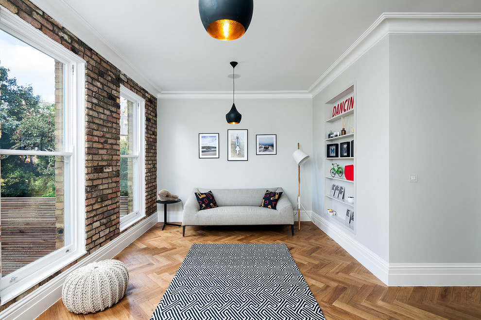 Design ideas for an eclectic living room in London with medium hardwood floors and no fireplace.