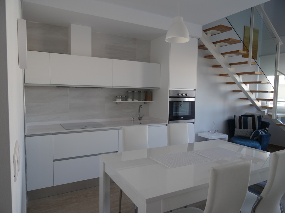 Design ideas for a small modern single-wall open plan kitchen in Alicante-Costa Blanca with an integrated sink, white cabinets, flat-panel cabinets and no island.