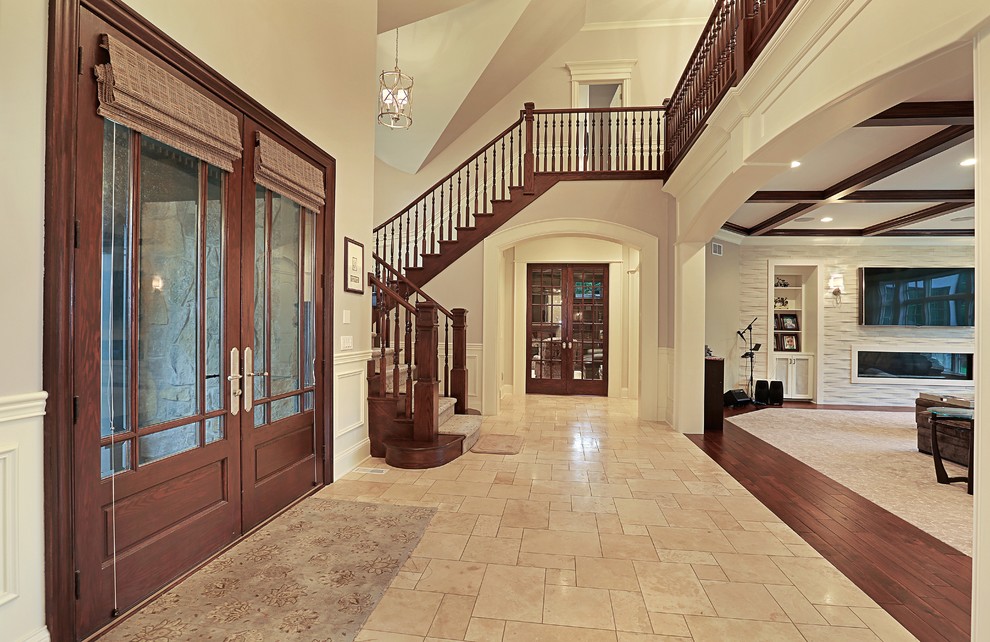 Large traditional foyer in Chicago with pink walls, ceramic floors, a double front door and a medium wood front door.