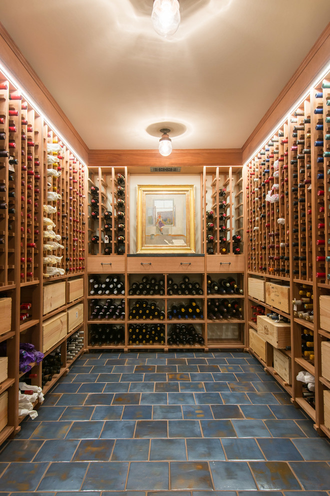 Design ideas for a mid-sized mediterranean wine cellar in Minneapolis with ceramic floors, storage racks and blue floor.