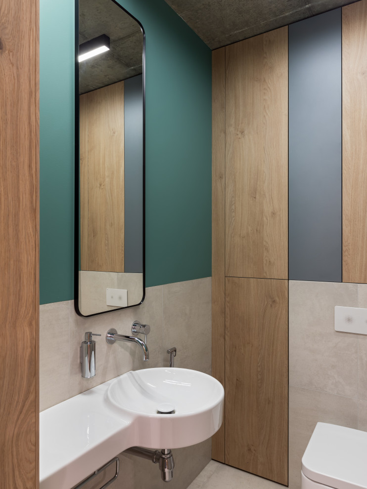 Пример оригинального дизайна: туалет среднего размера в стиле лофт с плоскими фасадами, серыми фасадами, серой плиткой, инсталляцией, керамогранитной плиткой, зелеными стенами, полом из керамогранита, подвесной раковиной и серым полом