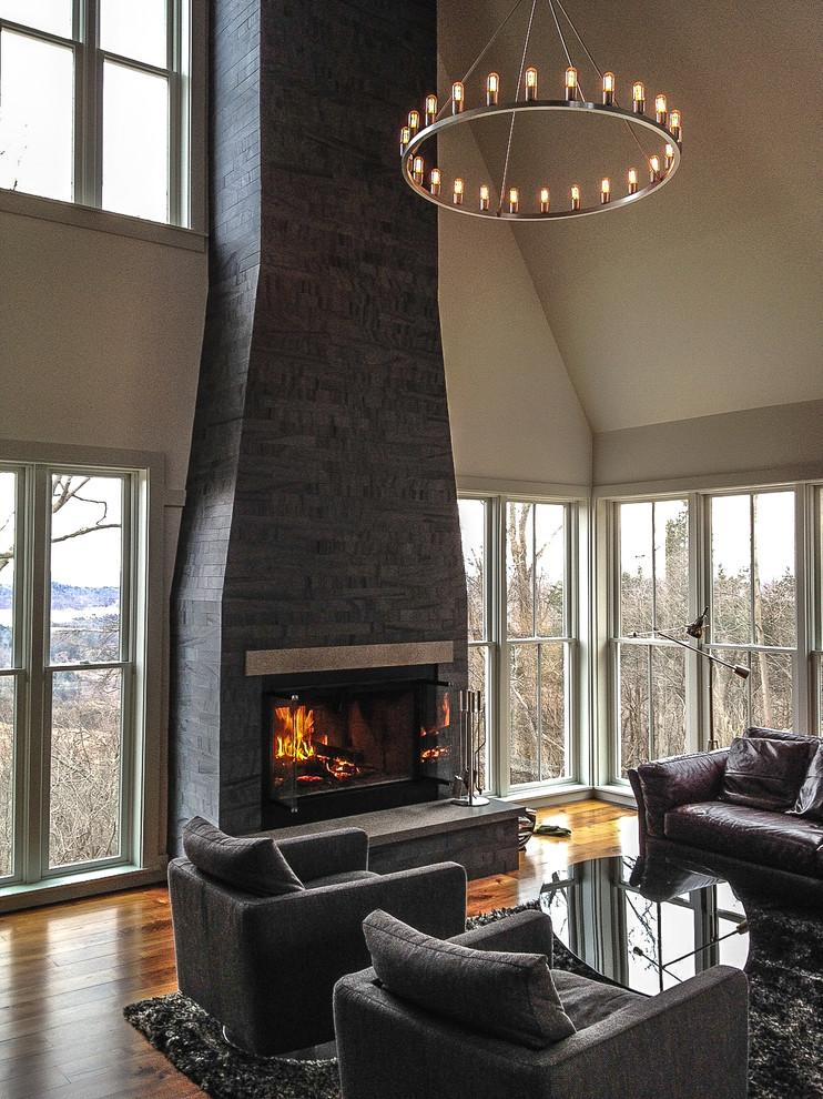 Inspiration for a modern living room in New York with a standard fireplace, a stone fireplace surround and no tv.