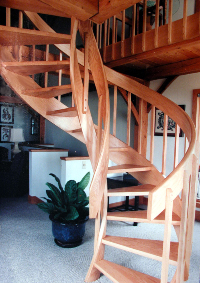 Inspiration for a large eclectic wood spiral staircase in Charlotte with wood risers.