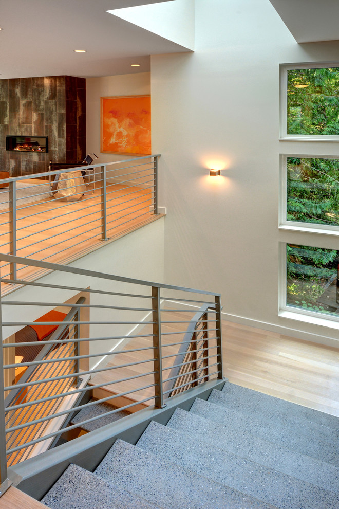 Inspiration for a large modern concrete u-shaped staircase in Seattle with open risers.