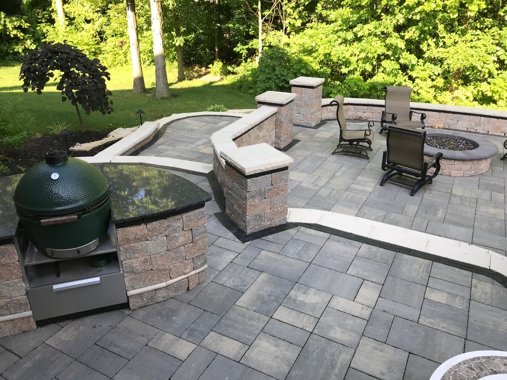 Design ideas for an expansive traditional backyard patio in Other with a fire feature, stamped concrete and no cover.