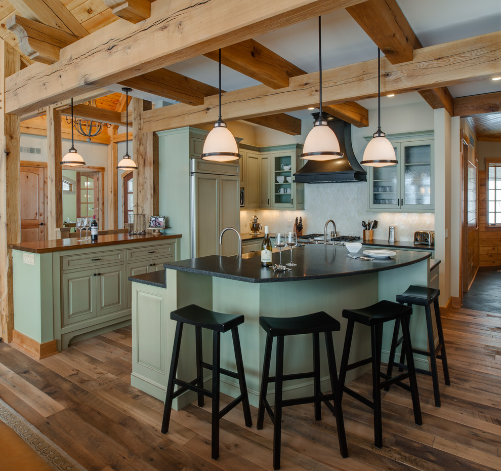 Mountain style kitchen photo with a farmhouse sink and recessed-panel cabinets