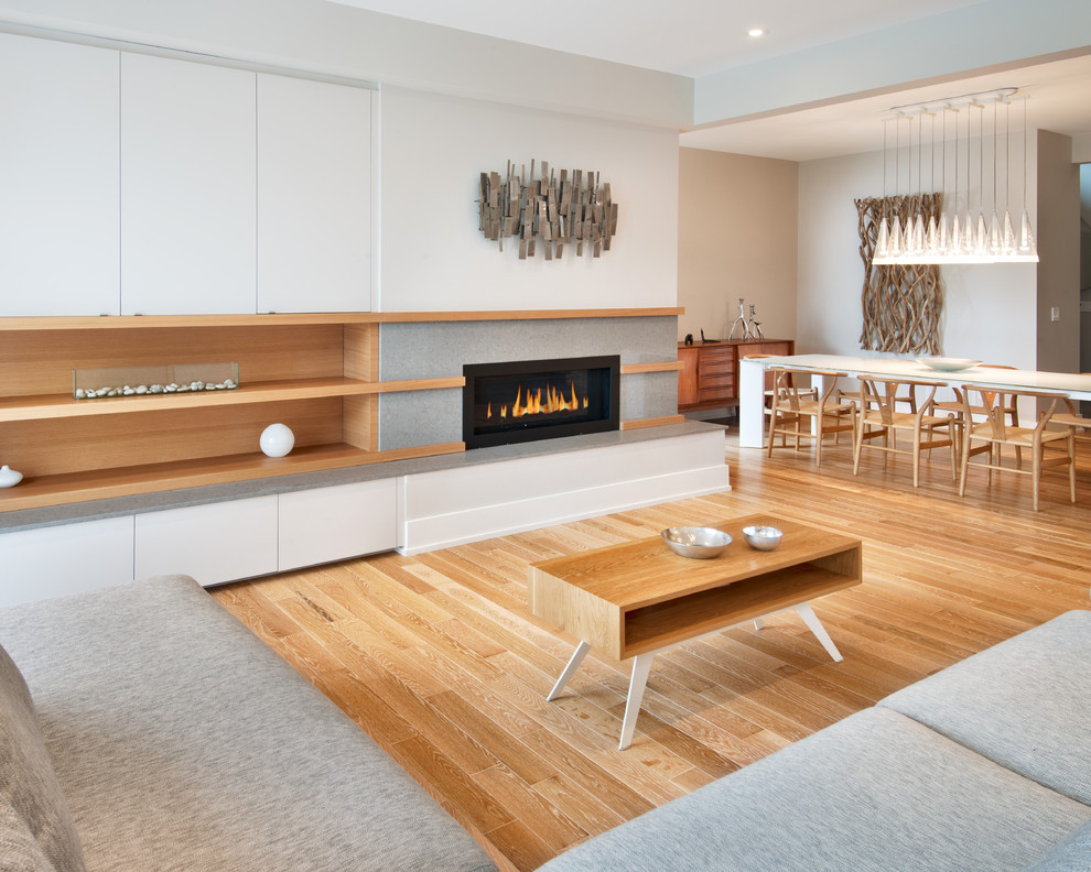 Photo of a contemporary open concept living room in Ottawa with a ribbon fireplace.