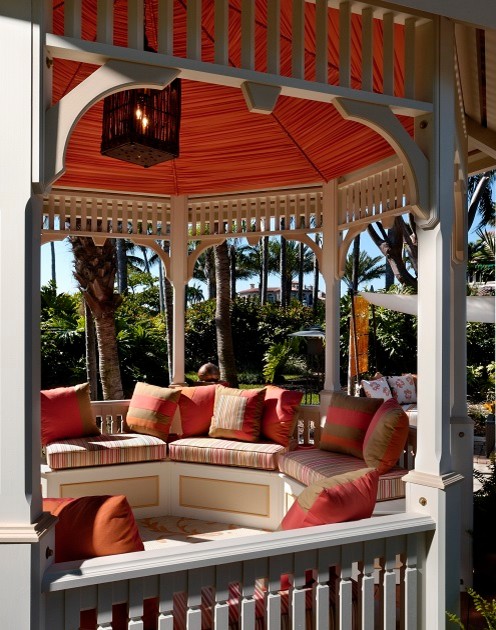 Design ideas for a large tropical backyard patio in Miami with brick pavers and a gazebo/cabana.