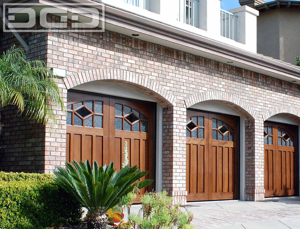 This is an example of an expansive traditional attached three-car garage in Orange County.