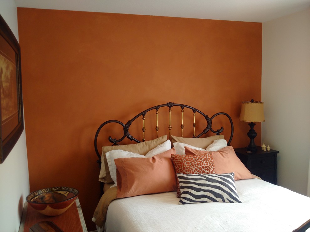 This is an example of a mid-sized contemporary guest bedroom in Calgary with orange walls, carpet and no fireplace.