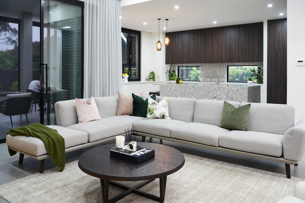 Design ideas for a contemporary living room in Melbourne with brown walls, porcelain floors, a standard fireplace, a wood fireplace surround, a built-in media wall and grey floor.