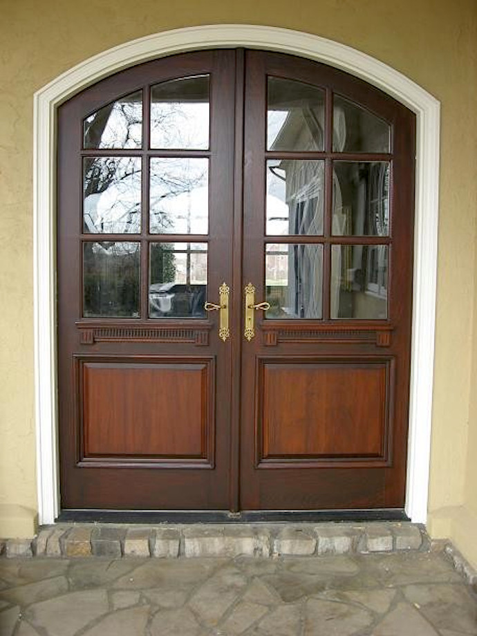 Photo of a mid-sized country front door in Other with a double front door and a dark wood front door.