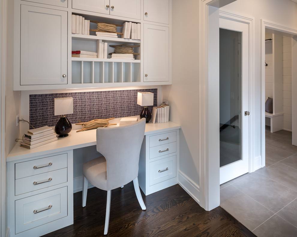 Example of a mid-sized transitional dark wood floor and brown floor kitchen design in New York with shaker cabinets, white cabinets and quartzite countertops
