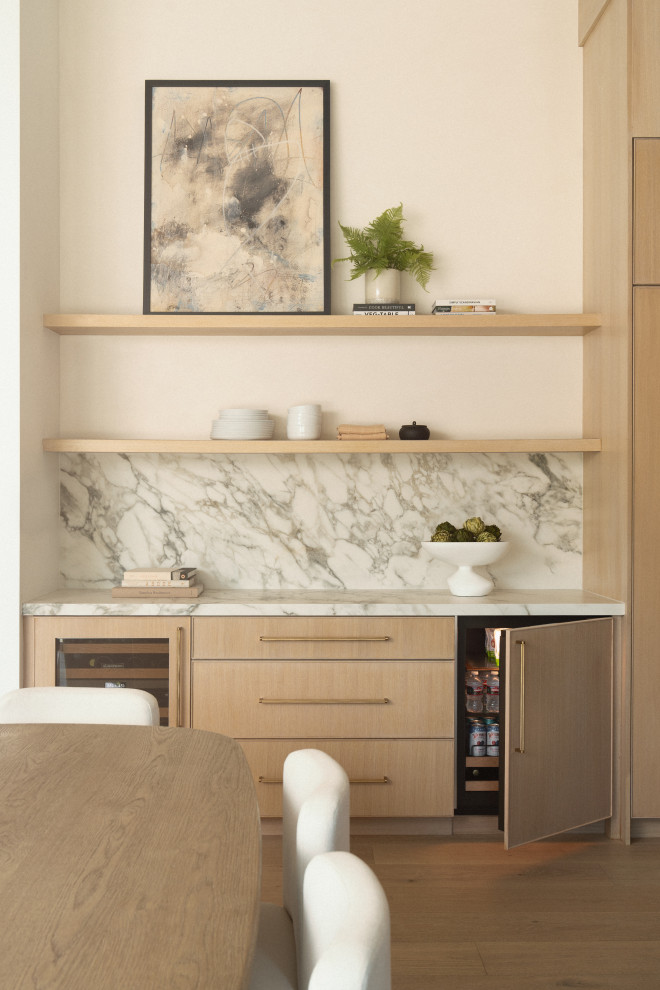 Example of a transitional home bar design in Orange County