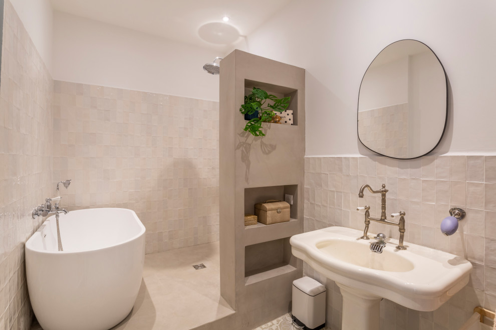 This is an example of a medium sized contemporary ensuite bathroom in Marseille with open cabinets, beige cabinets, a built-in bath, a built-in shower, a two-piece toilet, white tiles, terracotta tiles, white walls, cement flooring, a pedestal sink, beige floors, an open shower, white worktops, a single sink and a built in vanity unit.