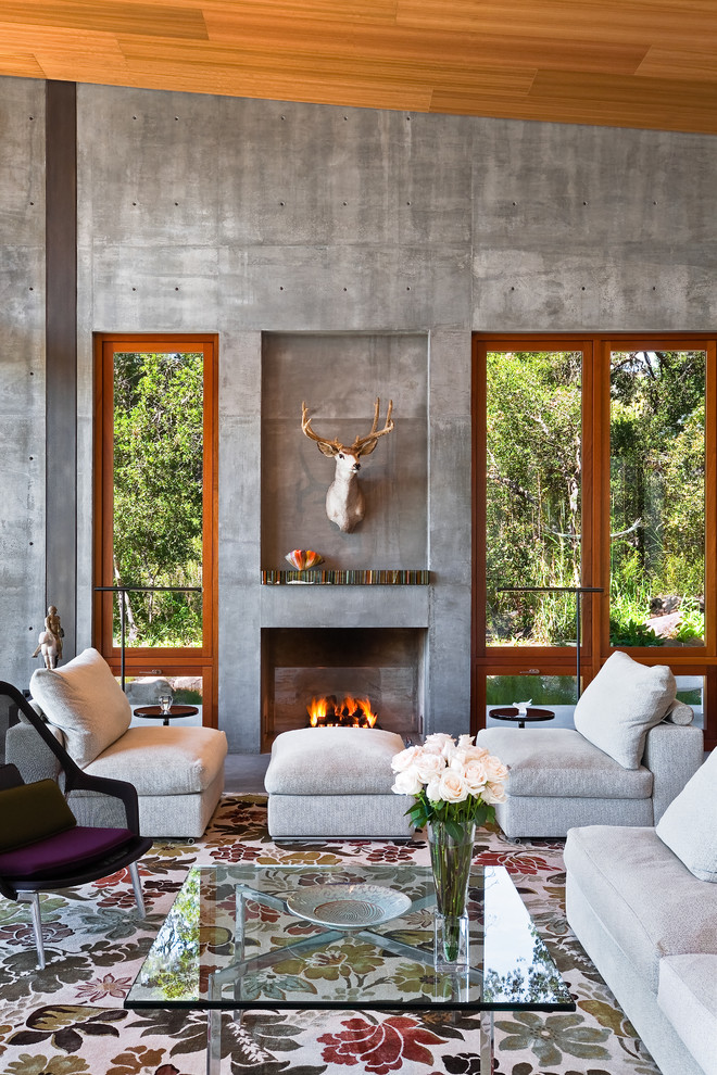 Photo of a contemporary formal living room in Los Angeles with grey walls and a standard fireplace.