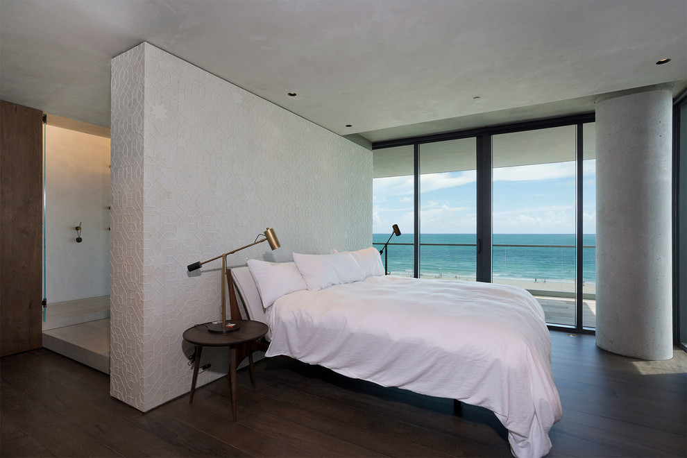This is an example of a mid-sized contemporary master bedroom in Miami with multi-coloured walls, dark hardwood floors and brown floor.