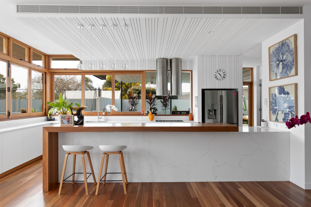 This is an example of a beach style kitchen in Brisbane.