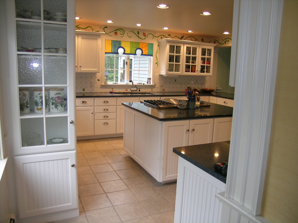 Large country u-shaped eat-in kitchen in Portland Maine with an undermount sink, louvered cabinets, white cabinets, granite benchtops, white splashback, porcelain splashback, stainless steel appliances, ceramic floors and with island.