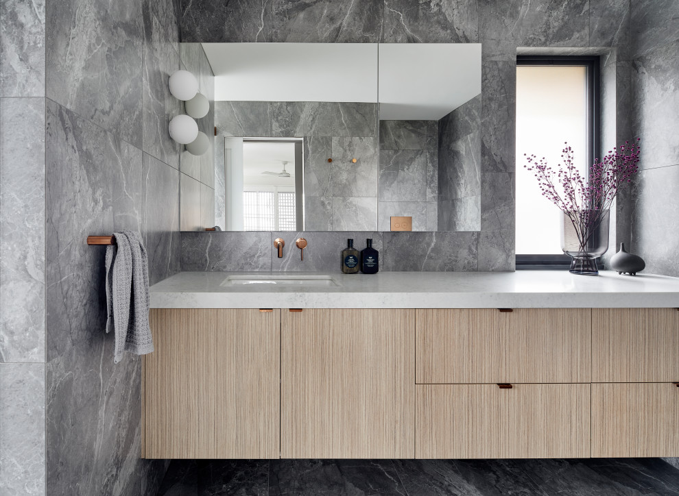 Contemporary wet room bathroom in Melbourne with furniture-like cabinets, medium wood cabinets, a two-piece toilet, gray tile, porcelain tile, grey walls, porcelain floors, an undermount sink, engineered quartz benchtops, grey floor, a hinged shower door, yellow benchtops, a single vanity and a floating vanity.
