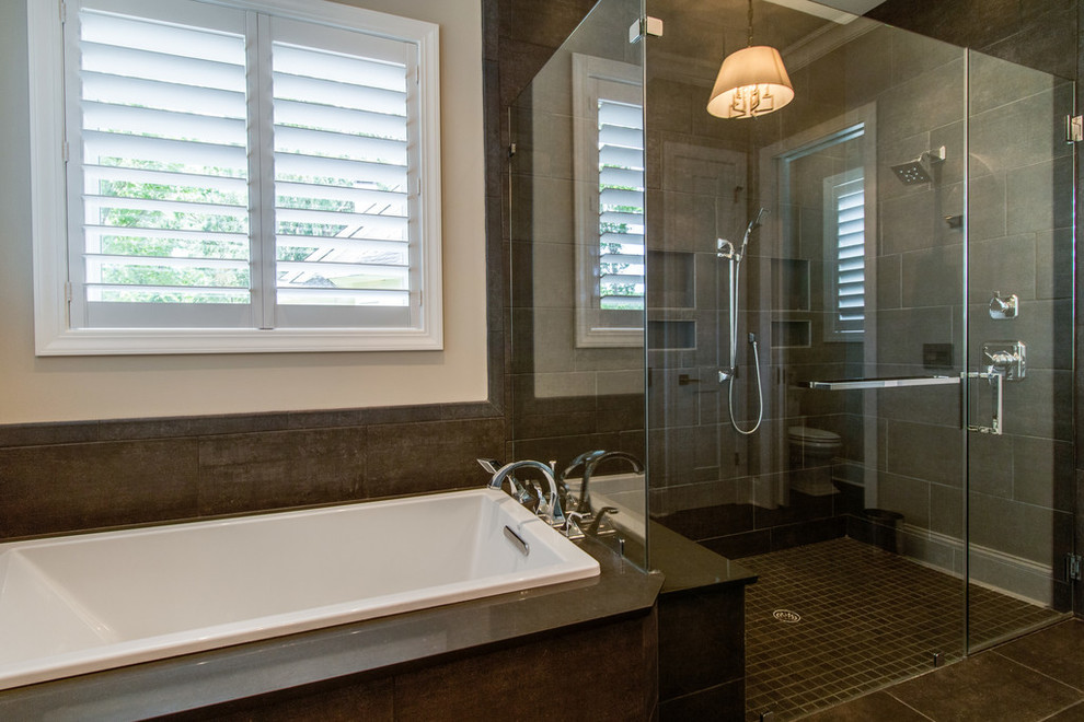 Large contemporary master bathroom in Charleston with shaker cabinets, grey cabinets, a drop-in tub, a corner shower, a one-piece toilet, brown tile, grey walls, porcelain floors, an undermount sink, engineered quartz benchtops, brown floor, a hinged shower door and porcelain tile.