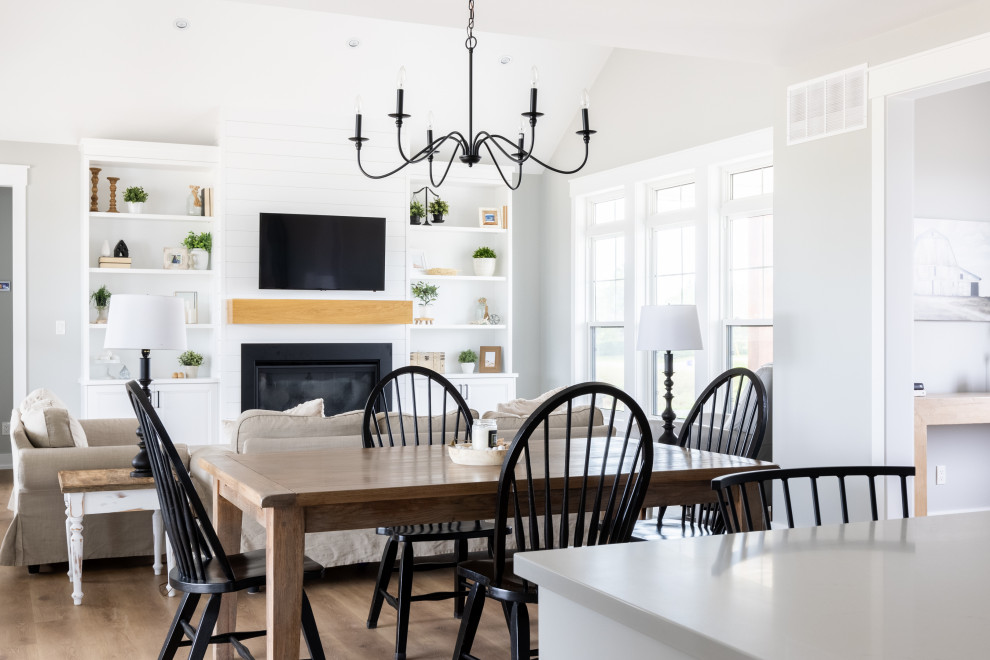 Inspiration for a mid-sized transitional l-shaped eat-in kitchen in Other with an undermount sink, shaker cabinets, white cabinets, quartz benchtops, shiplap splashback, stainless steel appliances, medium hardwood floors, with island, multi-coloured floor, white benchtop and vaulted.