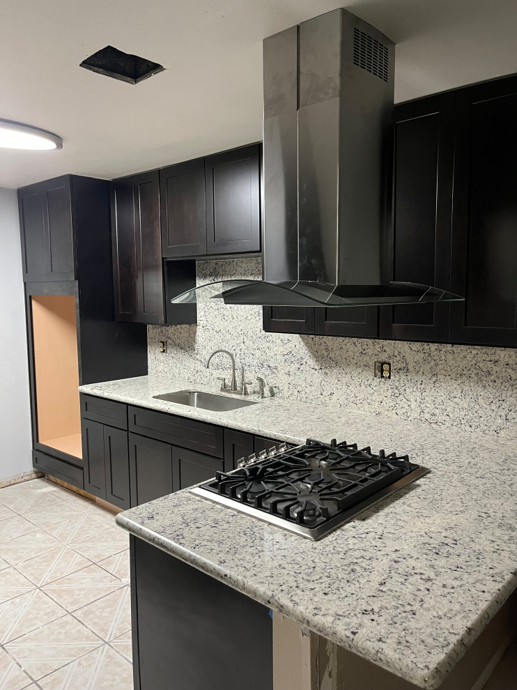 Mid-sized traditional l-shaped eat-in kitchen in Houston with a drop-in sink, shaker cabinets, brown cabinets, granite benchtops, white splashback, granite splashback, white appliances, no island and white benchtop.