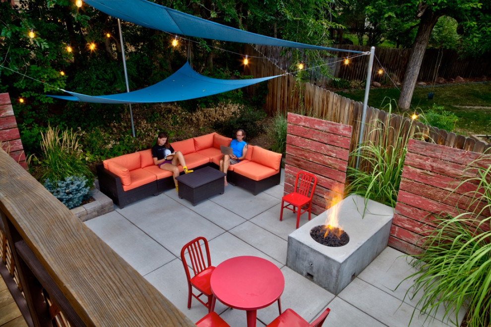 Photo of a small modern backyard partial sun garden in Denver with a fire feature.