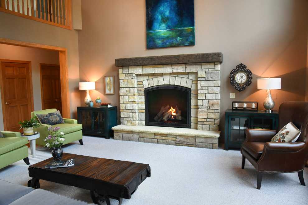 This is an example of an eclectic living room in Cleveland with a stone fireplace surround.