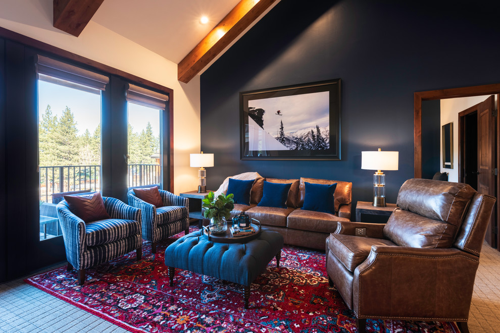 Inspiration for a mid-sized country open concept family room in Other with blue walls, carpet, a standard fireplace, a stone fireplace surround, a wall-mounted tv and multi-coloured floor.