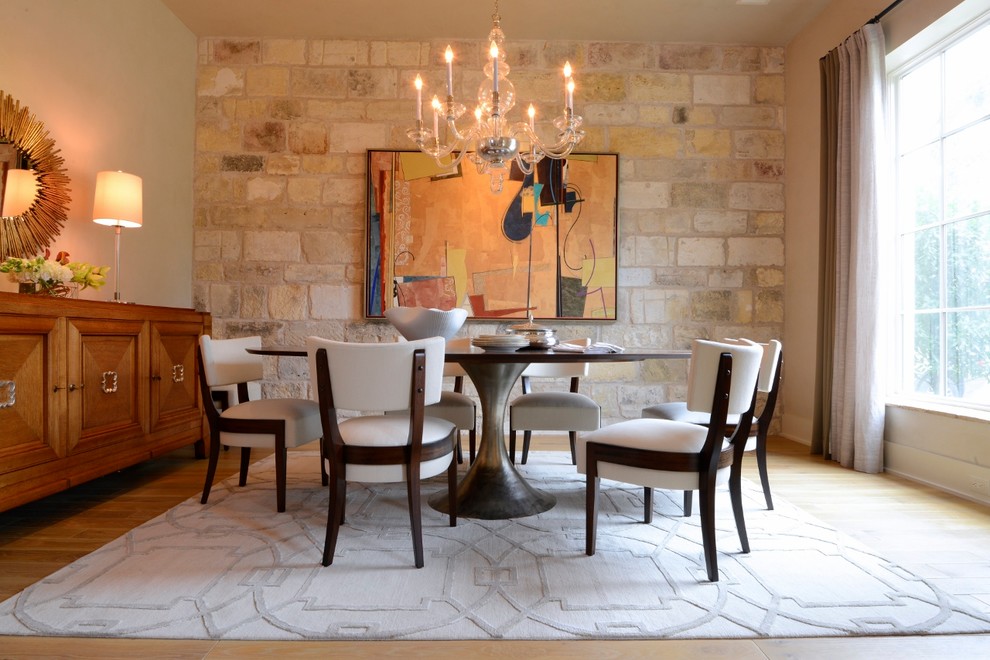 Design ideas for a mediterranean dining room in Houston with beige walls and light hardwood floors.