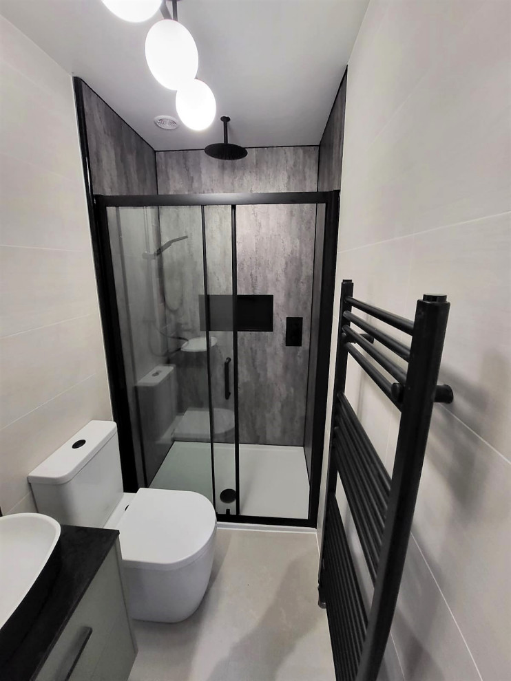 Mid-sized modern kids bathroom in Other with flat-panel cabinets, green cabinets, an alcove shower, a two-piece toilet, gray tile, porcelain tile, laminate floors, a vessel sink, terrazzo benchtops, grey floor, a sliding shower screen, black benchtops, a single vanity and a floating vanity.