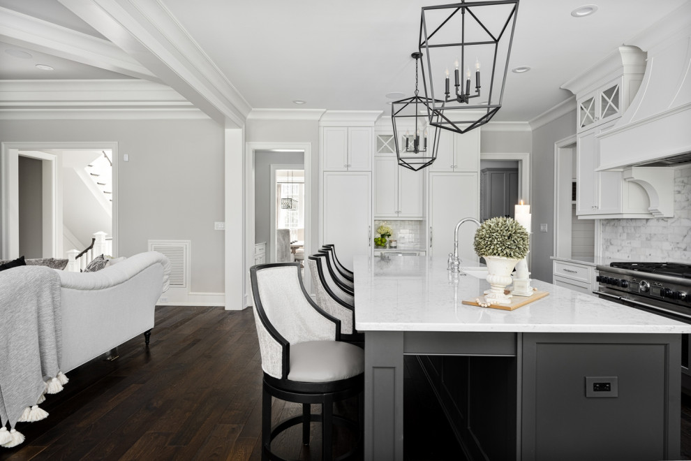 Design ideas for a medium sized classic kitchen in Raleigh with shaker cabinets, white cabinets, marble worktops, white splashback, black appliances, dark hardwood flooring, an island, brown floors and white worktops.