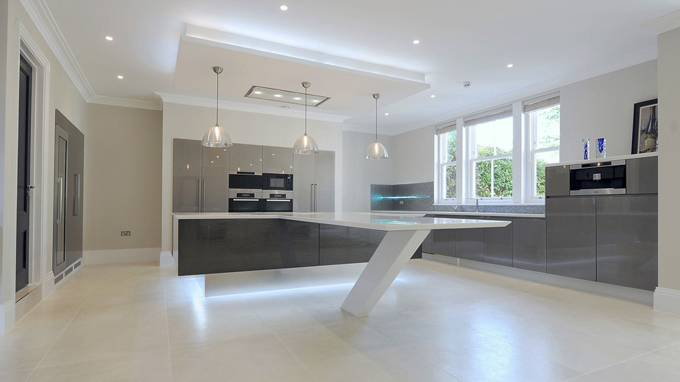 Expansive contemporary u-shaped open plan kitchen in London with an integrated sink, flat-panel cabinets, dark wood cabinets, solid surface benchtops, metallic splashback, glass sheet splashback, panelled appliances, porcelain floors and with island.