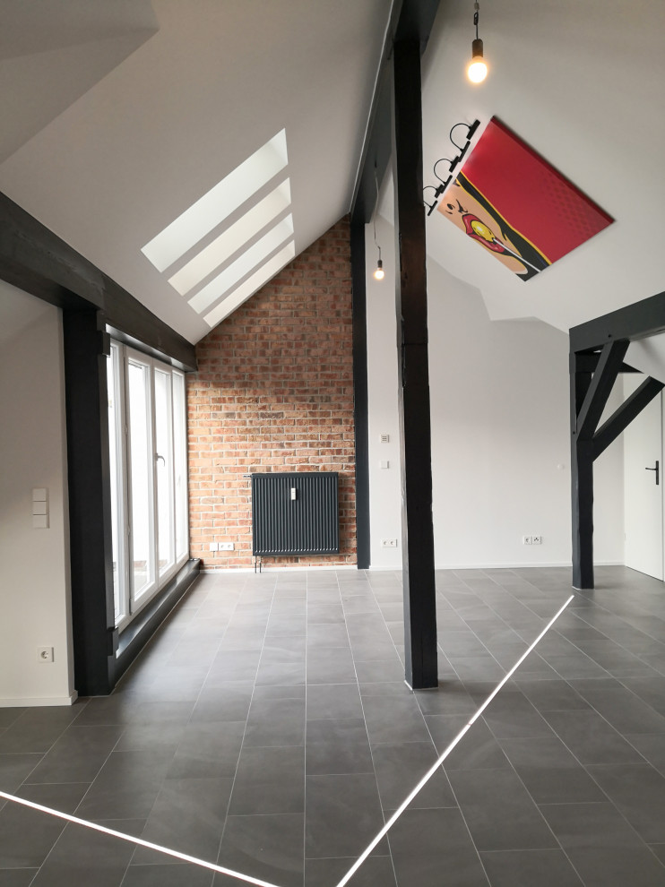 Living room - large contemporary loft-style ceramic tile and gray floor living room idea in Berlin with white walls and no fireplace