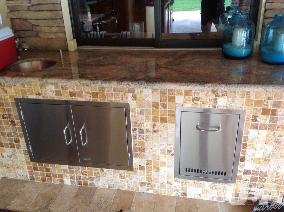 Kitchen - rustic travertine floor kitchen idea in Miami with stainless steel appliances