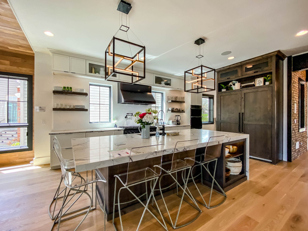 Inspiration for a huge transitional light wood floor and wood ceiling eat-in kitchen remodel in Chicago with a drop-in sink, shaker cabinets, white cabinets, quartz countertops, gray backsplash, mosaic tile backsplash, black appliances, an island and white countertops