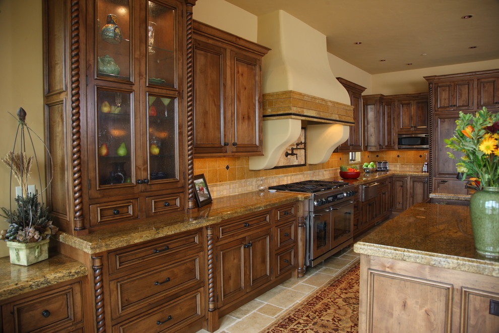 Inspiration for a large traditional l-shaped open plan kitchen in Seattle with an undermount sink, recessed-panel cabinets, distressed cabinets, granite benchtops, yellow splashback, ceramic splashback, stainless steel appliances, multiple islands and porcelain floors.
