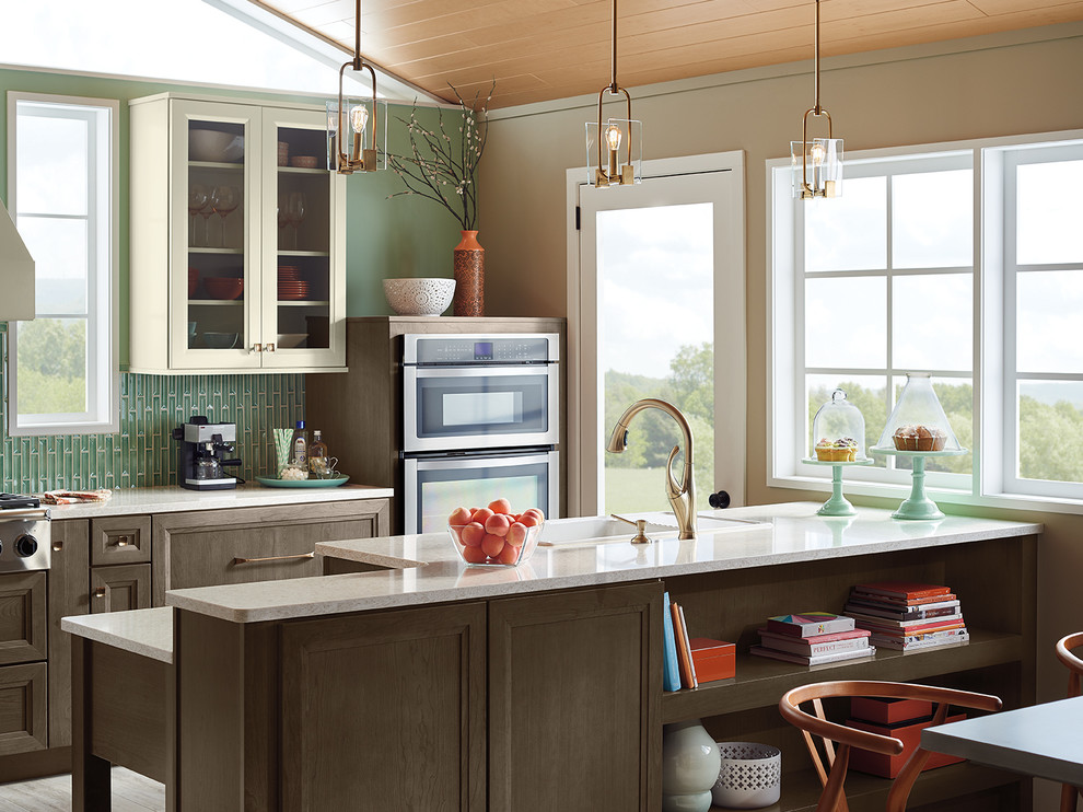 Transitional kitchen photo in Indianapolis with beige cabinets, green backsplash, stainless steel appliances and an island