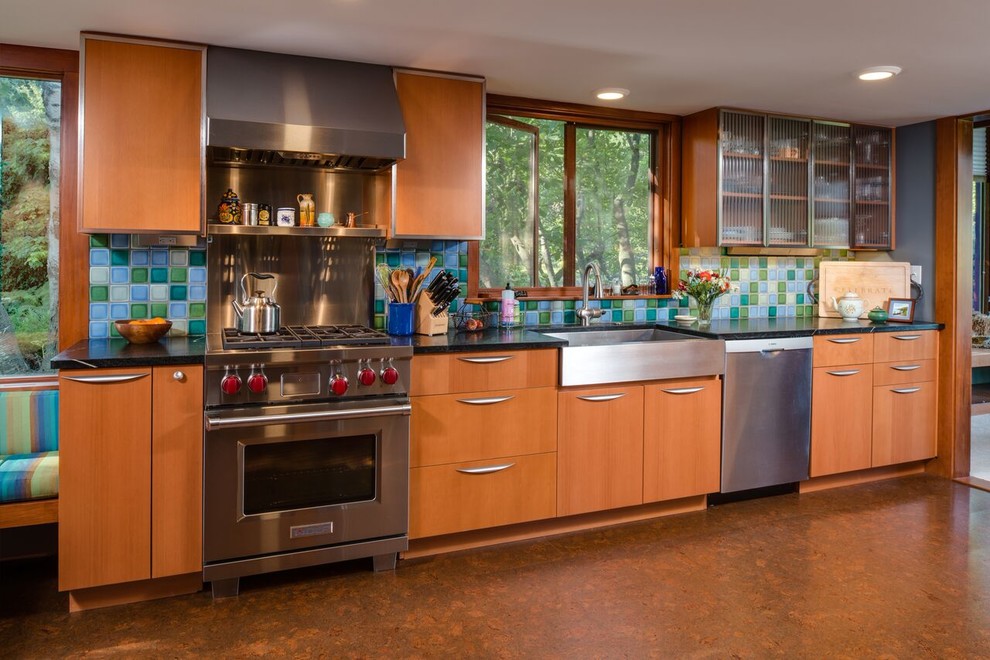 Mid-sized midcentury u-shaped separate kitchen in Other with a single-bowl sink, flat-panel cabinets, medium wood cabinets, multi-coloured splashback, stainless steel appliances, cork floors, no island and brown floor.